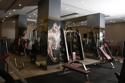 a gym with a picture of a man on the wall at Sandy Palace Hotel Amman in Amman