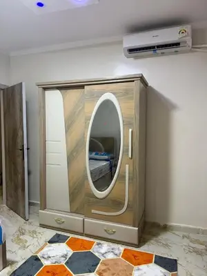 a room with a mirror in a wooden cabinet at Marco inn in Amman