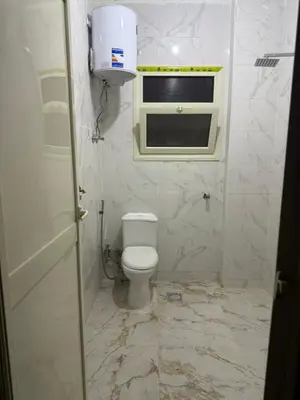 a small bathroom with a toilet and a window at Marco inn in Amman
