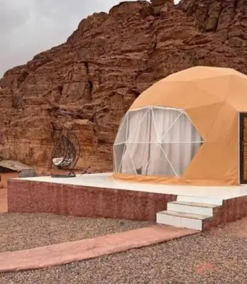 a tent is set up in front of a mountain at Wadi Rum March in Wadi Rum