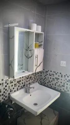 a bathroom with a sink and a mirror at Desert Horizon Camp in Disah