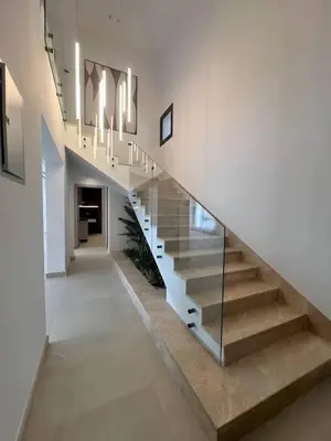 a staircase in a house with a glass railing at Jordan farm in Amman