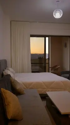 a bedroom with a large bed and a couch at قرية الراحة مرسى زايد باطلالات خلابة alraha village with Beautiful view in Aqaba