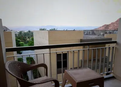 a chair and a table on a balcony with a view at قرية الراحة مرسى زايد باطلالات خلابة alraha village with Beautiful view in Aqaba