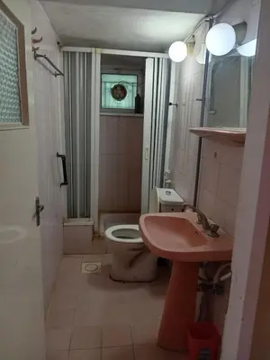 a small bathroom with a toilet and a sink at Al Martini Building Number 11 in Amman