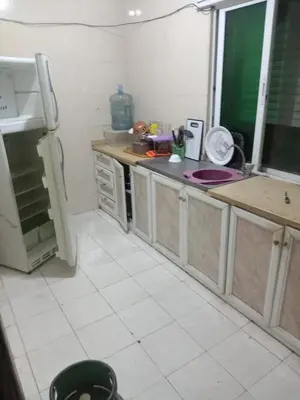 a kitchen with a refrigerator and a counter top at Al Martini Building Number 11 in Amman