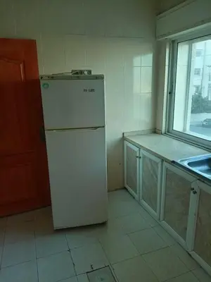 a white refrigerator in a kitchen with a window at Al Martini Building Number 11 in Amman
