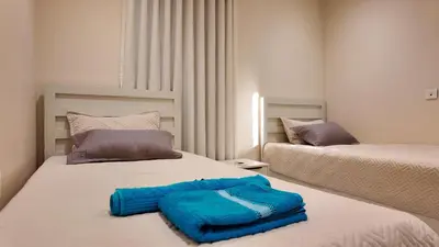 a bedroom with two beds with blue towels on it at واحة ايلة ازور in Aqaba