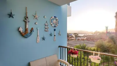 a blue wall with clocks on a balcony at شقه للإيجار في ايله للعائلات in Aqaba