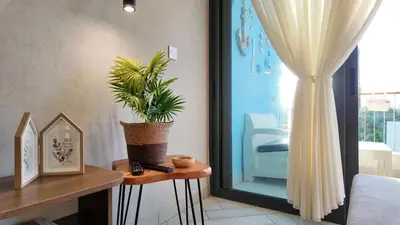 a room with a plant on a table next to a window at شقه للإيجار في ايله للعائلات in Aqaba