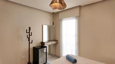 a kitchen with a refrigerator and a cross on the wall at شقه للإيجار في ايله للعائلات in Aqaba