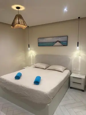 a bedroom with a bed with blue pillows on it at شقه للإيجار في ايله للعائلات in Aqaba