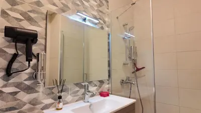 a bathroom with a sink and a shower with a mirror at شقه للإيجار في ايله للعائلات in Aqaba