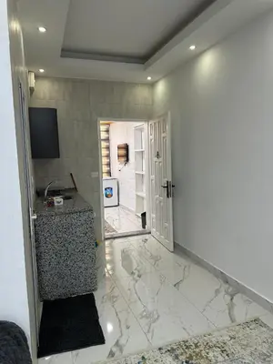 a room with a hallway with a door and a counter at Omar rent apartments in Amman