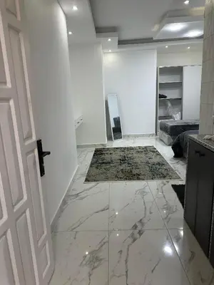 a white room with a door and a marble floor at Omar rent apartments in Amman