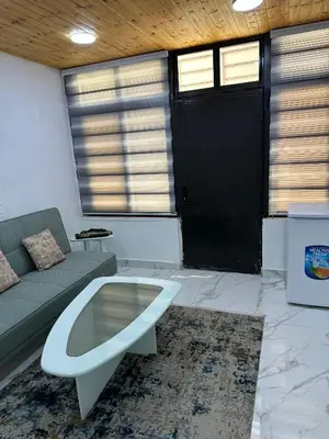 a living room with a couch and a coffee table at Omar rent apartments in Amman
