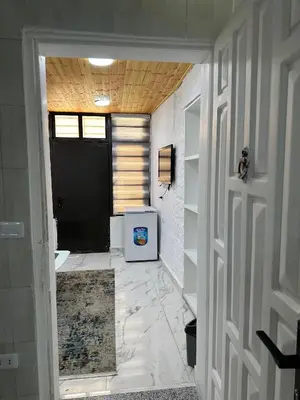 a hallway leading to a bathroom with a door at Omar rent apartments in Amman