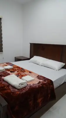 a bed with two towels on top of it at Petra Luminous Apartment in Wadi Musa