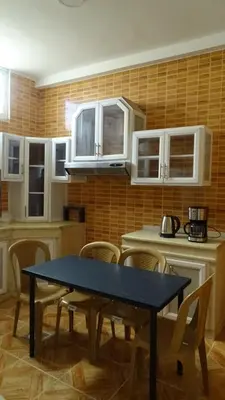 a kitchen with a blue table and chairs in it at Petra Luminous Apartment in Wadi Musa