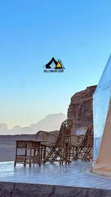 a group of chairs and a table on the beach at millennium camp in Wadi Rum