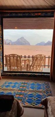 a room with a view of the desert through a window at Wadi Rum Aura Camp in Wadi Rum