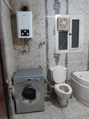 a small bathroom with a toilet and a sink at Amman house in Amman