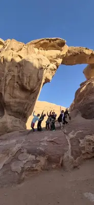 a group of people standing on a rock formation at Bedouin Luxe Camp & Tour in Wadi Rum