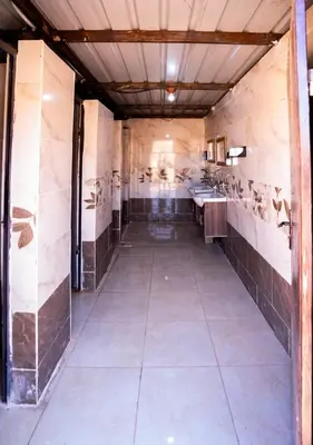 an empty bathroom with two sinks and ailed floor at Sunrise Magic Camp in Wadi Rum