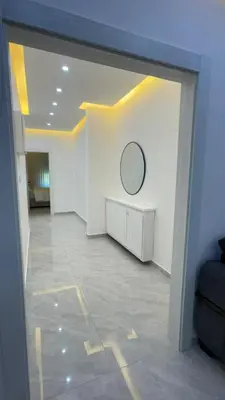 a large white room with a mirror on the wall at Luxury 3 Bedroom Family Apartment in Amman in Amman