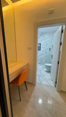 a bathroom with a wooden table and a bathroom with a toilet at Luxury 3 Bedroom Family Apartment in Amman in Amman