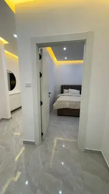 a bedroom with a bed and a door to a room at Luxury 3 Bedroom Family Apartment in Amman in Amman