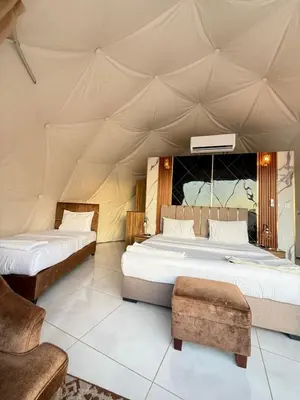 a bedroom with two beds in a tent at TALA lUXURY CAMP in Wadi Rum