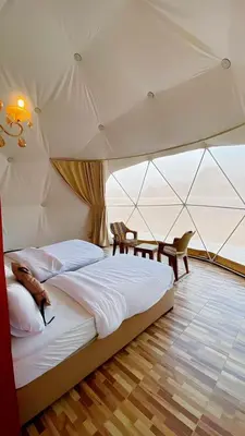 a bedroom with a large bed in a tent at TALA lUXURY CAMP in Wadi Rum