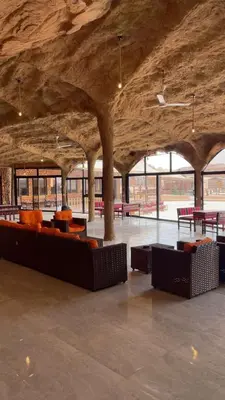 a large room with couches and tables in a building at Starlight Camp in Disah