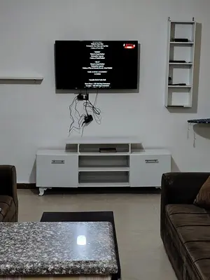 a living room with a flat screen tv on a wall at الرائد للشقق المفروشة in Amman