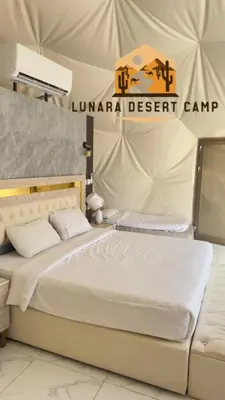 a bedroom with a bed in a tent at Lunara Desert Luxury Camp in Wadi Rum