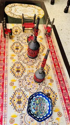 a table with a table cloth with two pots and a table sidx sidx at New Hamoudeh Hotel in Amman