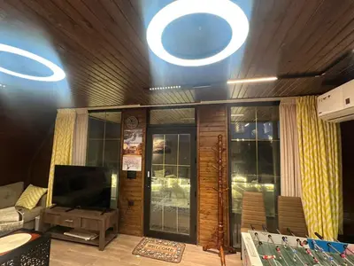 a living room with a television and a couch at Umm Aljulud Cottages 01 in Ajloun