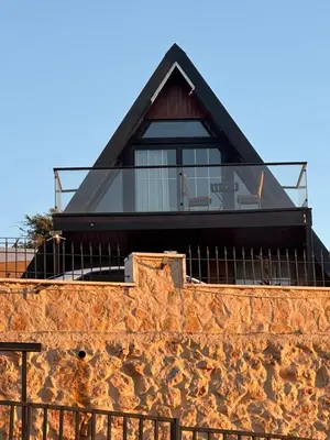 a house on top of a stone wall at Umm Aljulud Cottages 01 in Ajloun