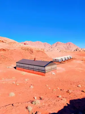 a building in the middle of the desert at Wadi Rum Sands Story Camp &Tours in Wadi Rum