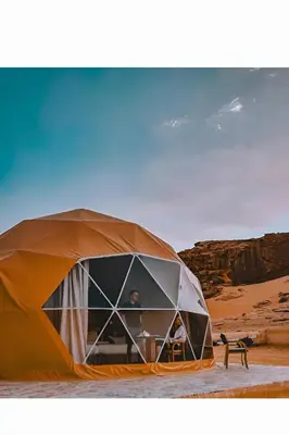 a man in a tent in the desert at Wadi rum tenda camp in Wadi Rum