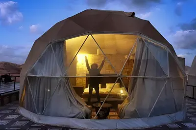 a person standing inside of a tent at Wadi rum tenda camp in Wadi Rum