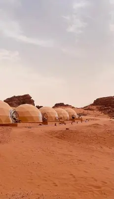 a group of domes in the desert on a dirt field at Nomads Heaven in Disah