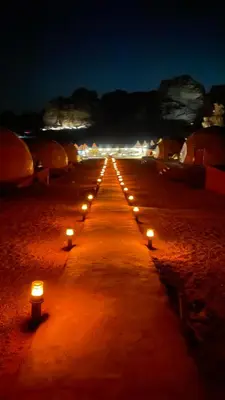a row of candles on a beach at night at Nomads Heaven in Disah