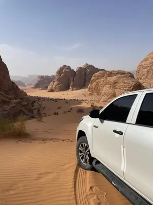 a white car parked in the desert at Nomads Heaven in Disah