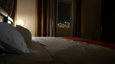 a bedroom with a bed and a window with a light at Petra center suite in Wadi Musa