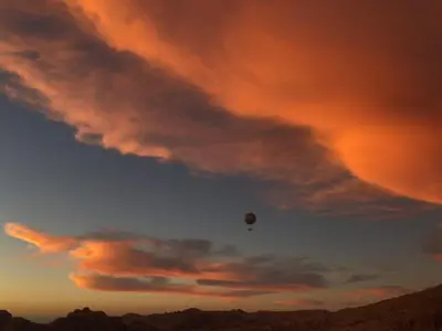 a hot air balloon in the sky at sunset at Petra center suite in Wadi Musa