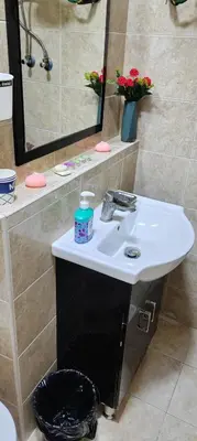 a bathroom with a white sink and a mirror at Fully furnished studio in Amman