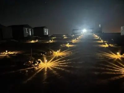 a row of lights on a street at night at Dana Sunset camp in Nijil