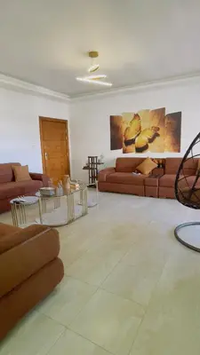 a living room with couches and tables in a room at شقة مفروشة في طبربور in Amman